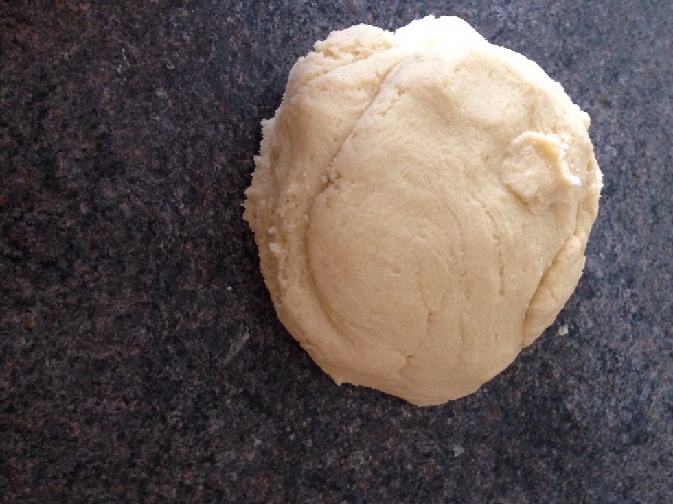 Combine the crumbly mixture with your hands to form a smooth dough.