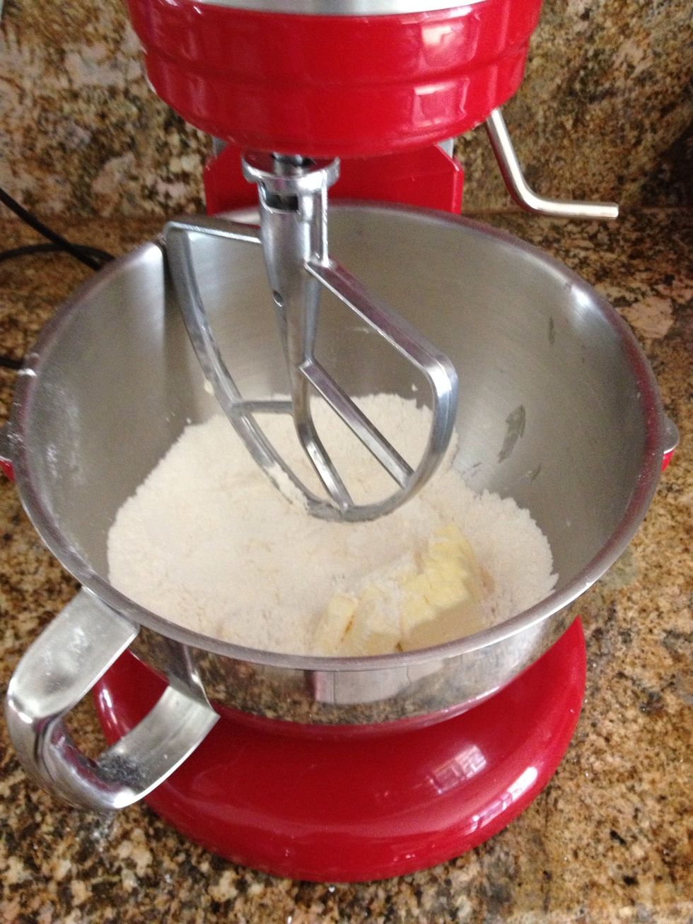 Combine the flour, confectioners' sugar, cornstarch, and salt in a medium bowl. Add the chilled butter and mix until the ingredients begin to come together in small clumps.