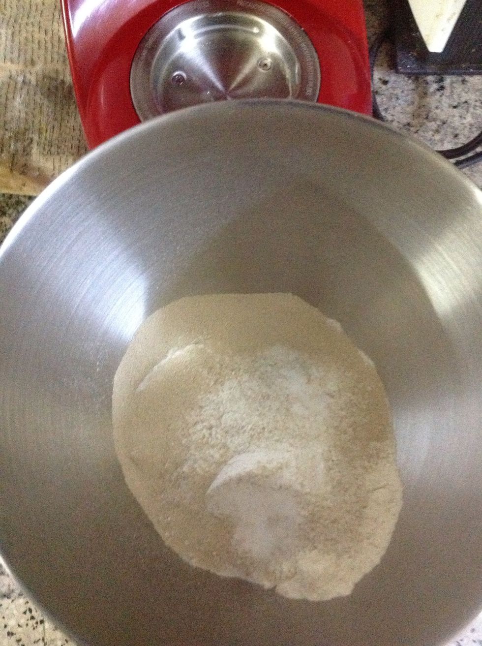 Combine the flours, yeast and salt in the bowl of an electric mixer or a big mixing bowl if mixing by hand. Mix until combined.