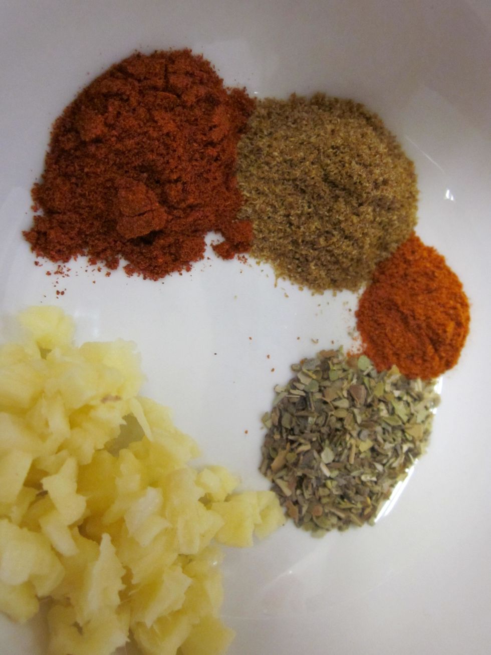 Combine the ginger root with paprika, cumin, oregano, cayenne pepper, and turmeric.