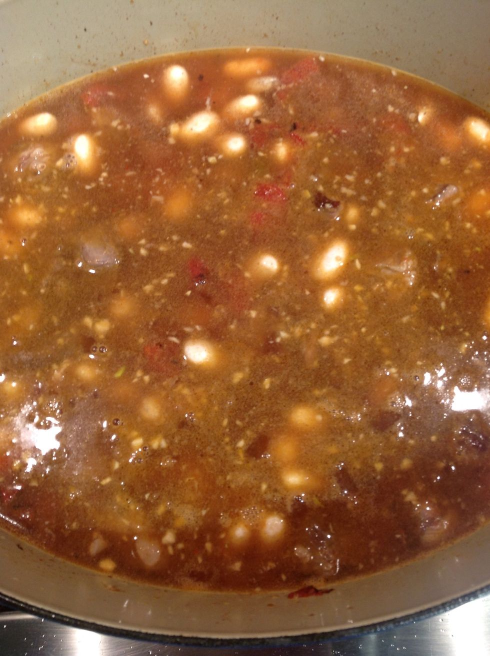 Combine the ingredients and cover with just sufficient water to cover, bring to a boil cover and put into pre-heated oven 300F reduce heat to 250F.  Cook for two hours, stir in greens and cook 1 hour.
