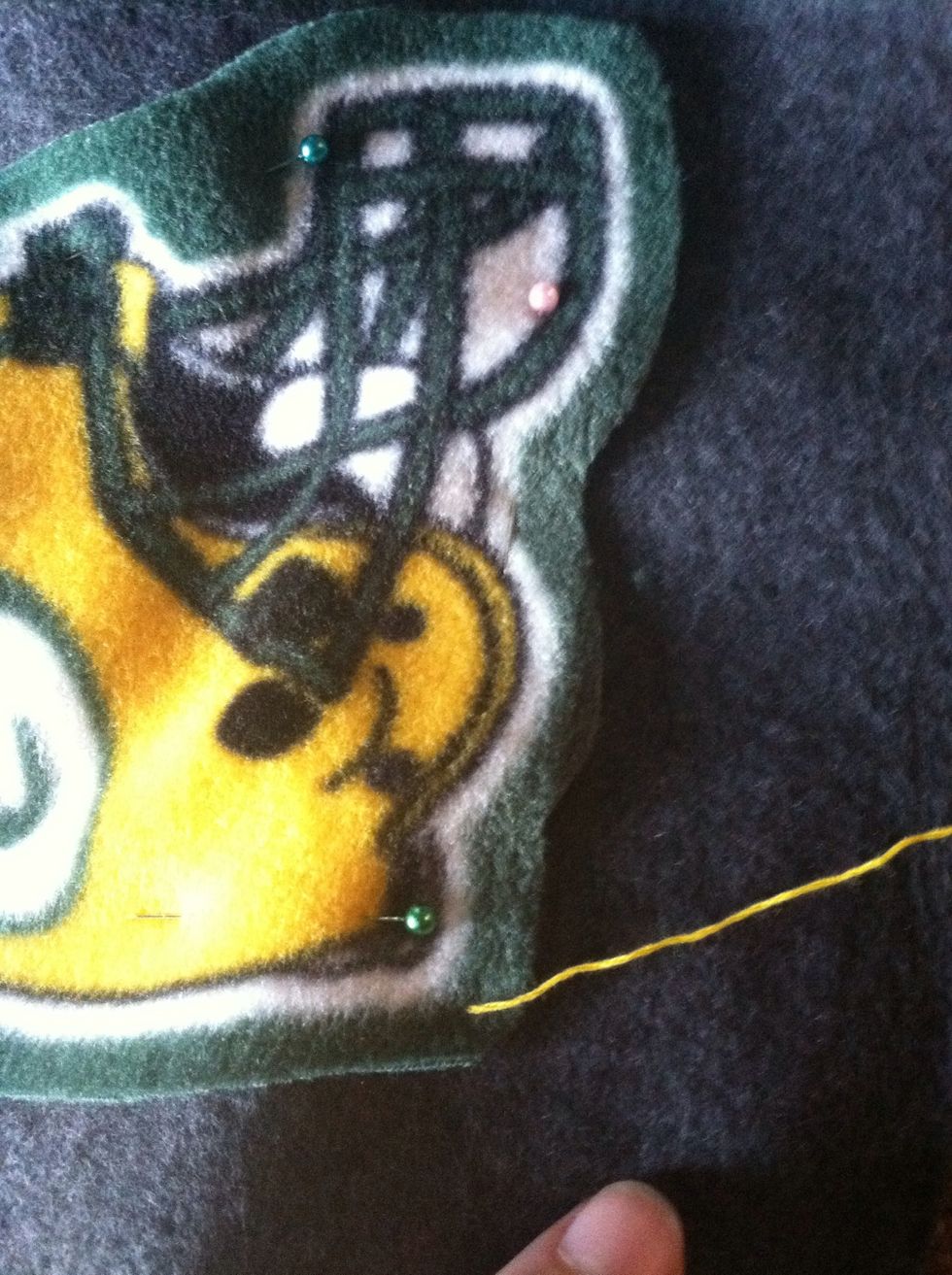 Come straight up through both pieces of fabric about 1/4" in from the edge of the appliqu\u00e9.