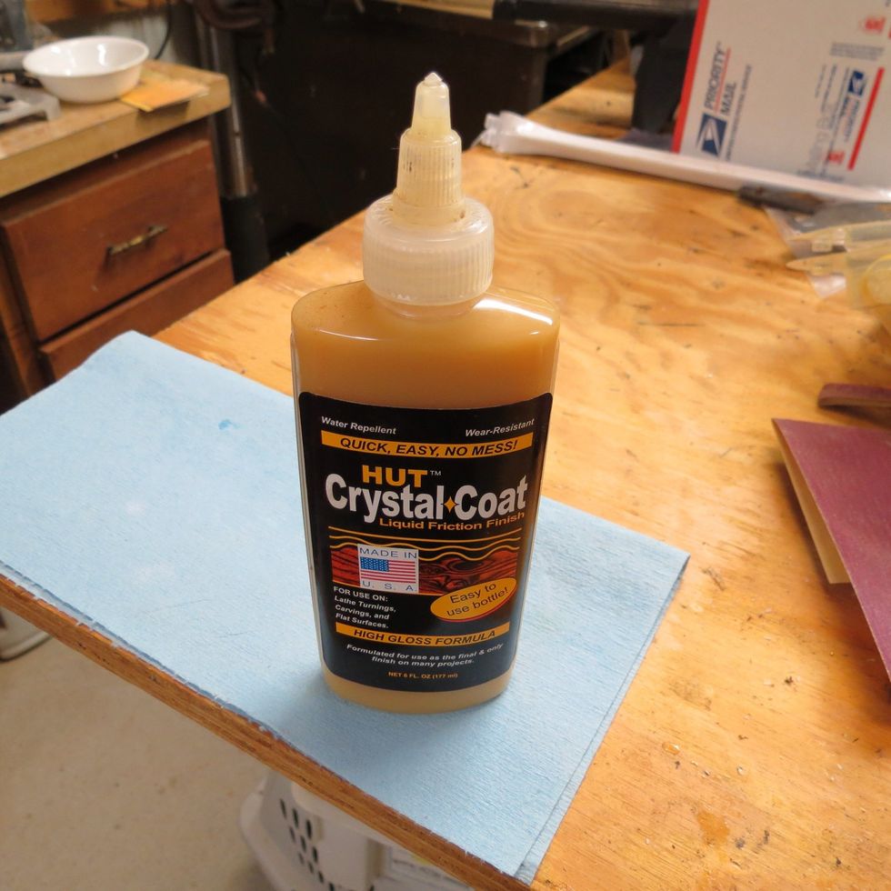 Complete the sanding, and then inspect for scratches or imperfections. Next, take a clean cloth, and apply a friction polish. Some people like to use a lacquer or the CA glue to finish the pen.