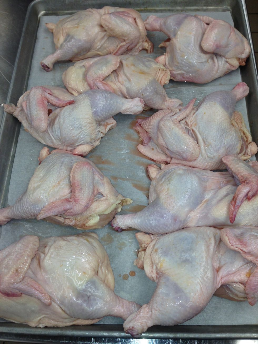 Completely defrost the chicken under refrigeration on lined sheet trays. This will take between 24 and 36 hours. Remove the trays from the walk-in and take them to your prep area.