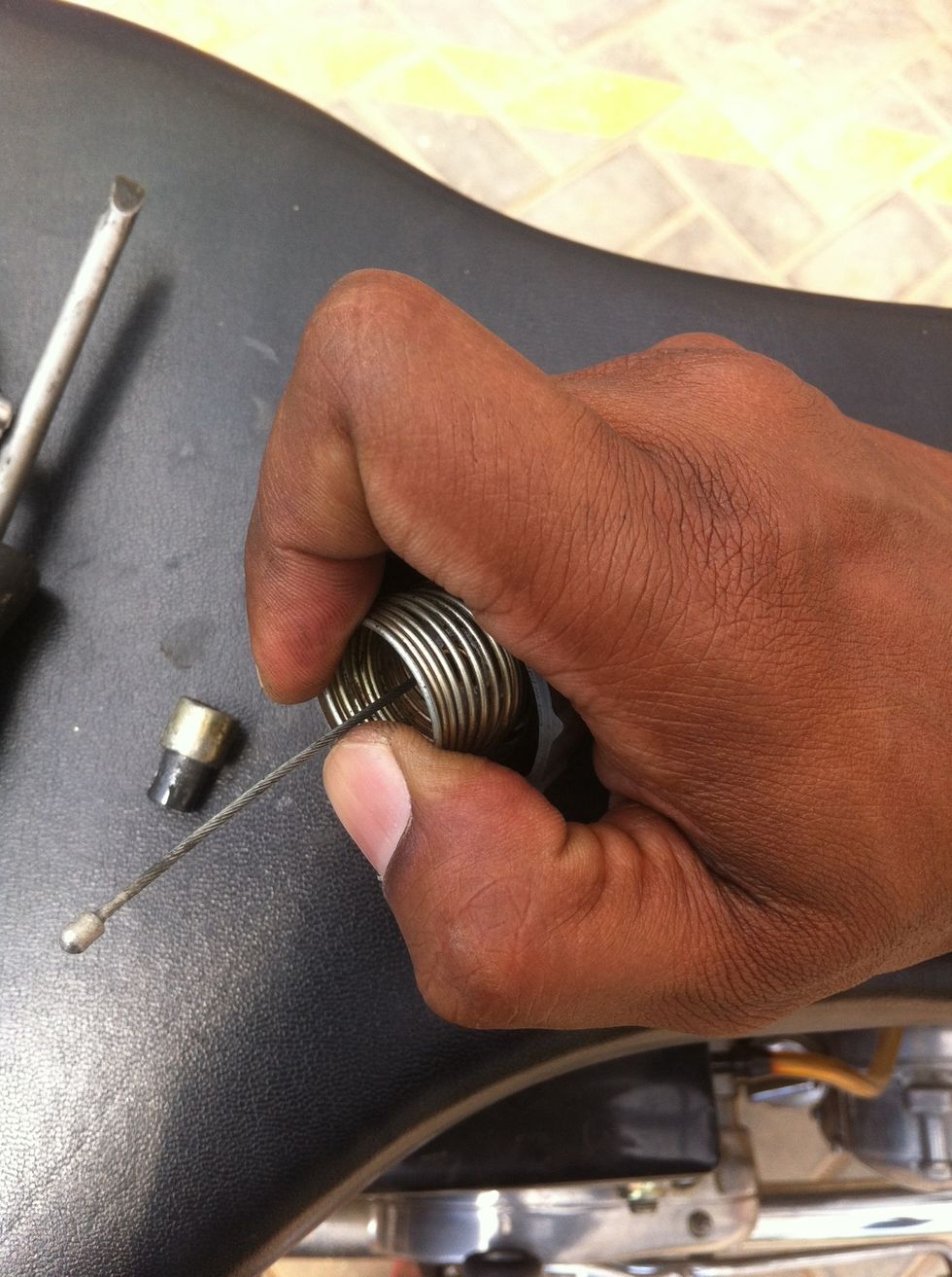 Compress the spring and get as much cable length that can be achieved.