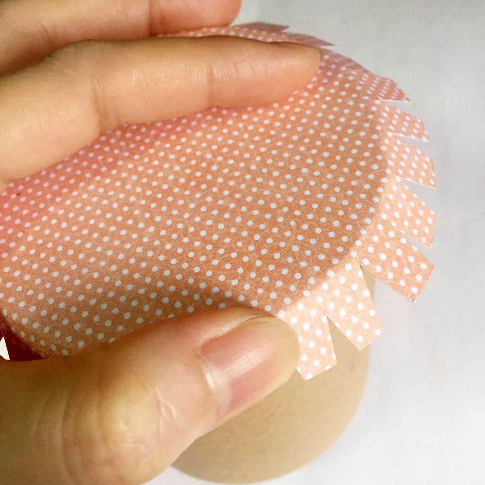 Condition the tabs by pushing them down around the roll using your thumb.