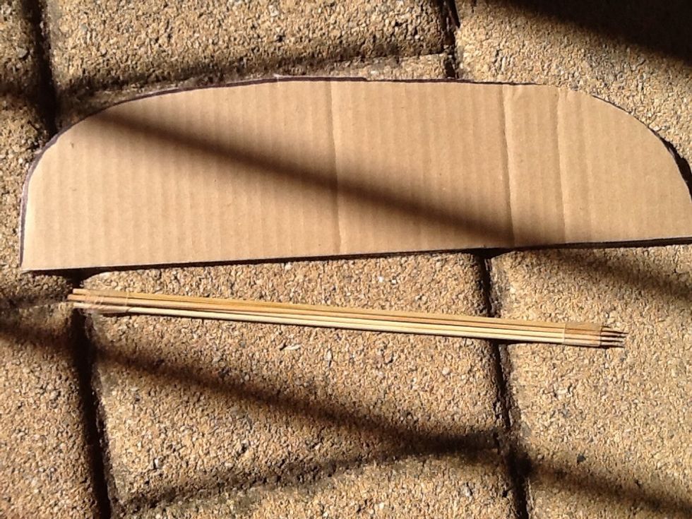Connect 4 skewers together, wrapping sticky tape around them for security. Afterwards, cut out two long hemisphere shapes out of cardboard for the wings.