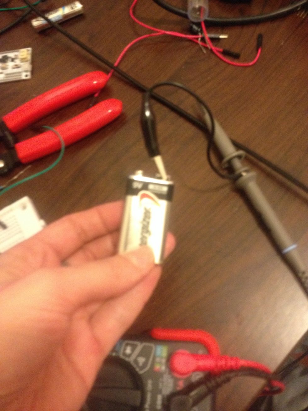 Connect one end of the probe to the negative terminal