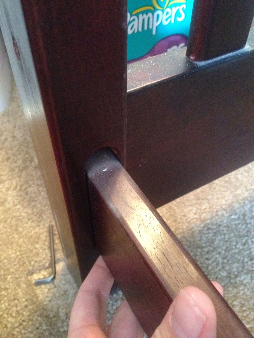 Connect side panels to baseboards. Place in grooves in front. Make sure the grooved side of the baseboards faces in and the drilled hole is up. (See next photo.)