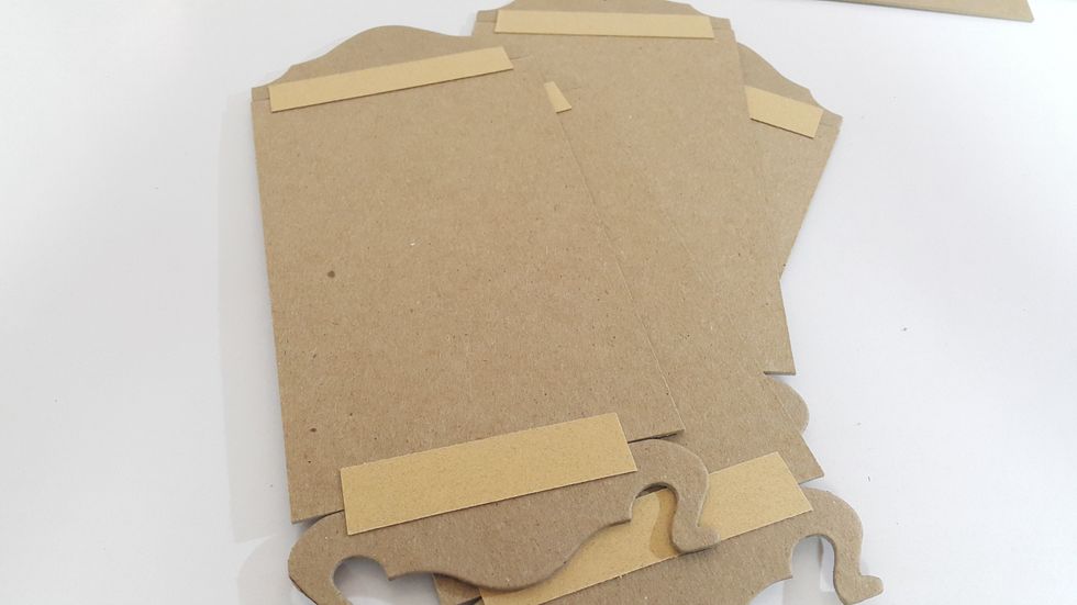 Connect the die-cut shapes and the panels together with scraps and double sided tape
