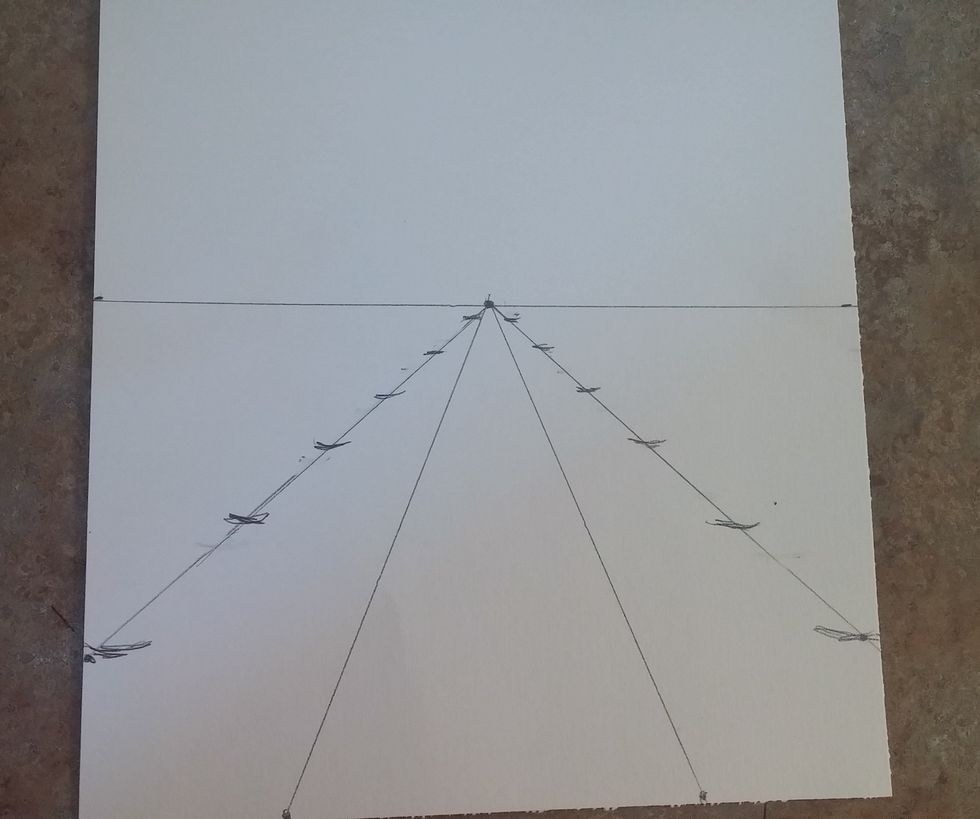 Connect the dots we just made at 9 inches on both sides to the vanishing point. Then place markers where the bottom of your trees will sit. Closer trees will have more space between them,