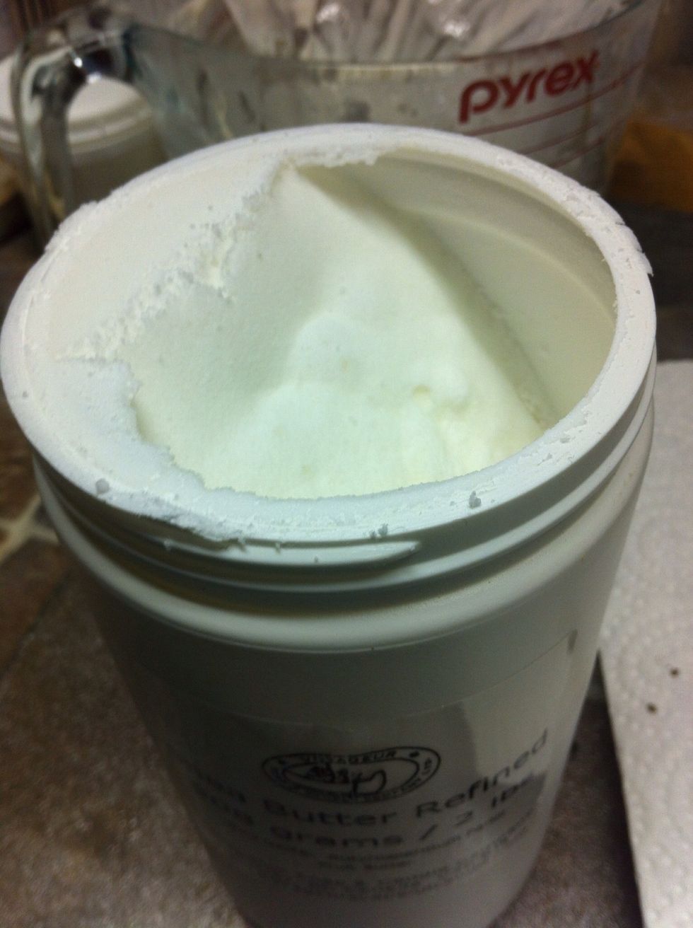 Consider shea butter. It will glide smoothly on your skin and will melt nicely. Mango and cocoa butters are good too, but they melt at higher temperatures. Or try a combination of two or three.