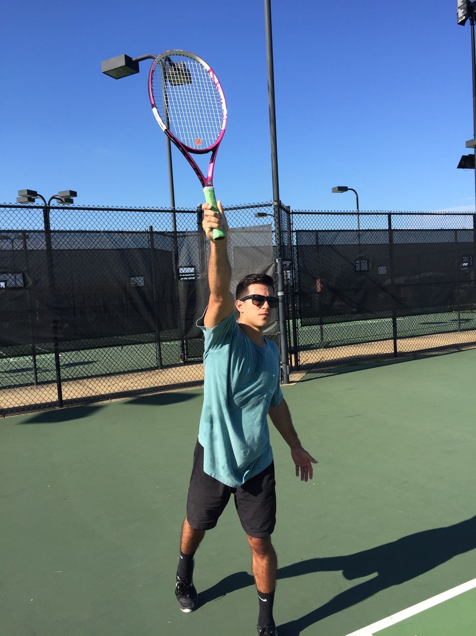 Contact: transfer your weight from back to front foot. Contact the ball in front of the lead foot at the apex of the racquets reach.