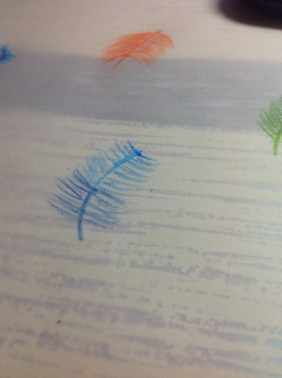 Continue adding the dark blue feathers.