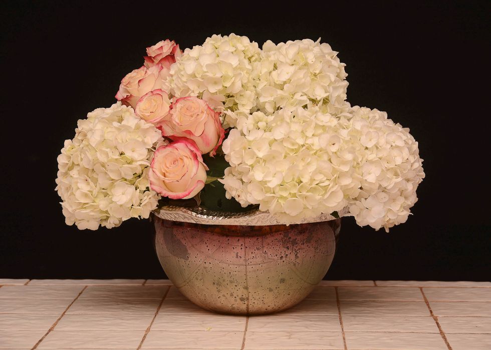 Continue adding your roses filling in that slight opening from one side of the design to the other\u2026..