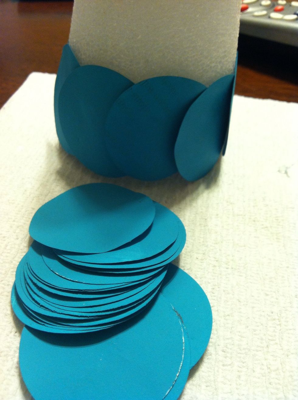 Continue all the way around, placing glue half on the edge of the circle and half on the styrofoam so the new row adheres to both. This will keep the rows in place.