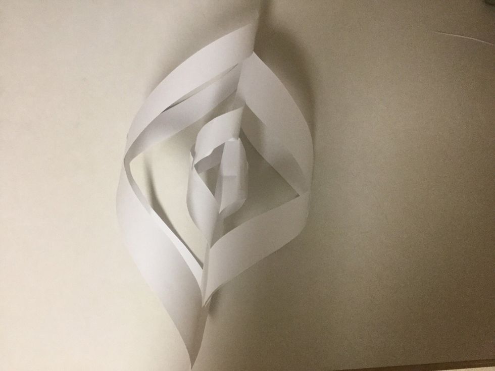 Continue alternating between sides to tape flaps together until they all have been taped. The papers should look like this when this step is finished.