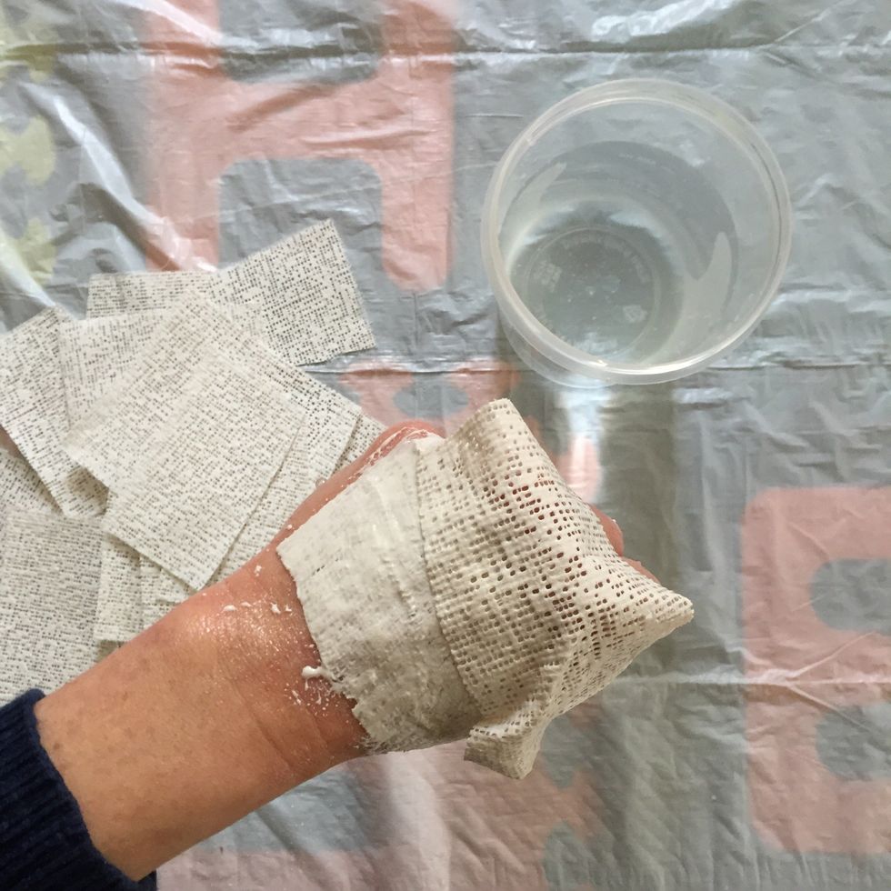 Continue applying strips to hand, ensuring that each piece overlaps the one placed before it