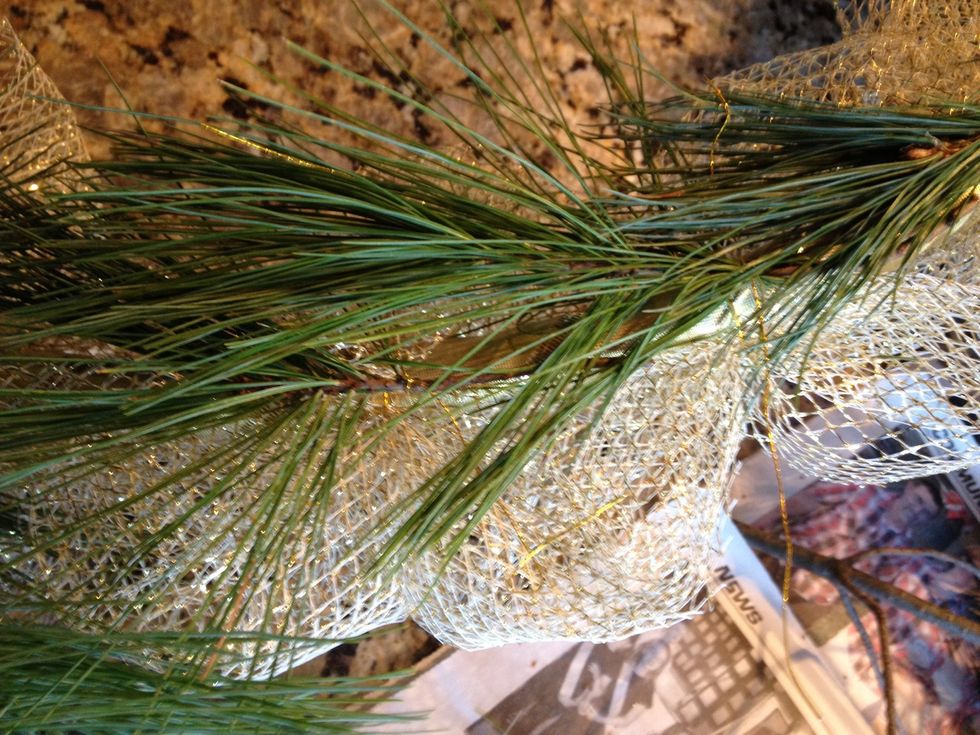 Continue around the hoop, overlapping the sprigs to cover the twigs.