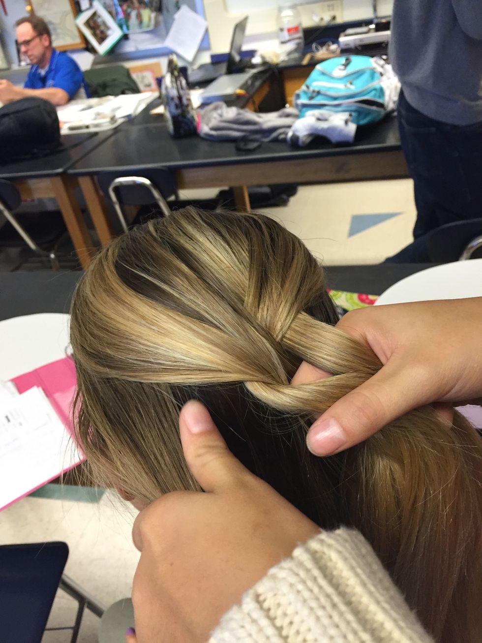 Continue braiding but add a small section of hair to each side every time
