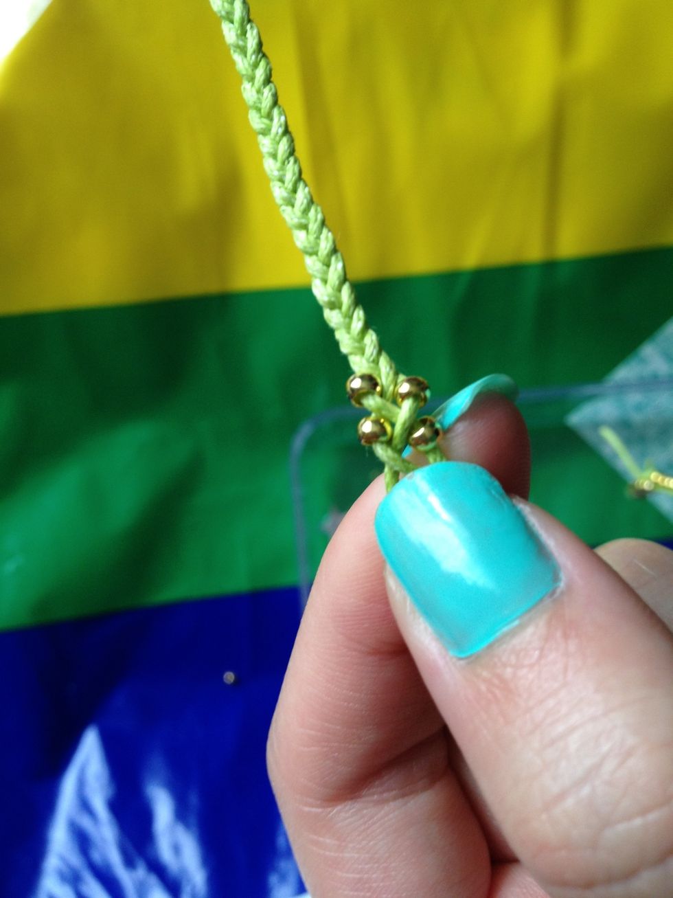 Continue braiding through, only this time, adding one bead each time. Do this to your desired length - measure against your wrist. REMEMBER there is still a length to braid after the beads!