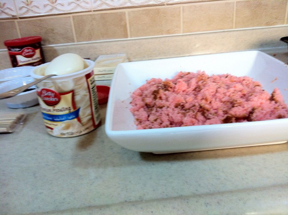Continue breaking it into smaller pieces then add about 2 spoons of frosting