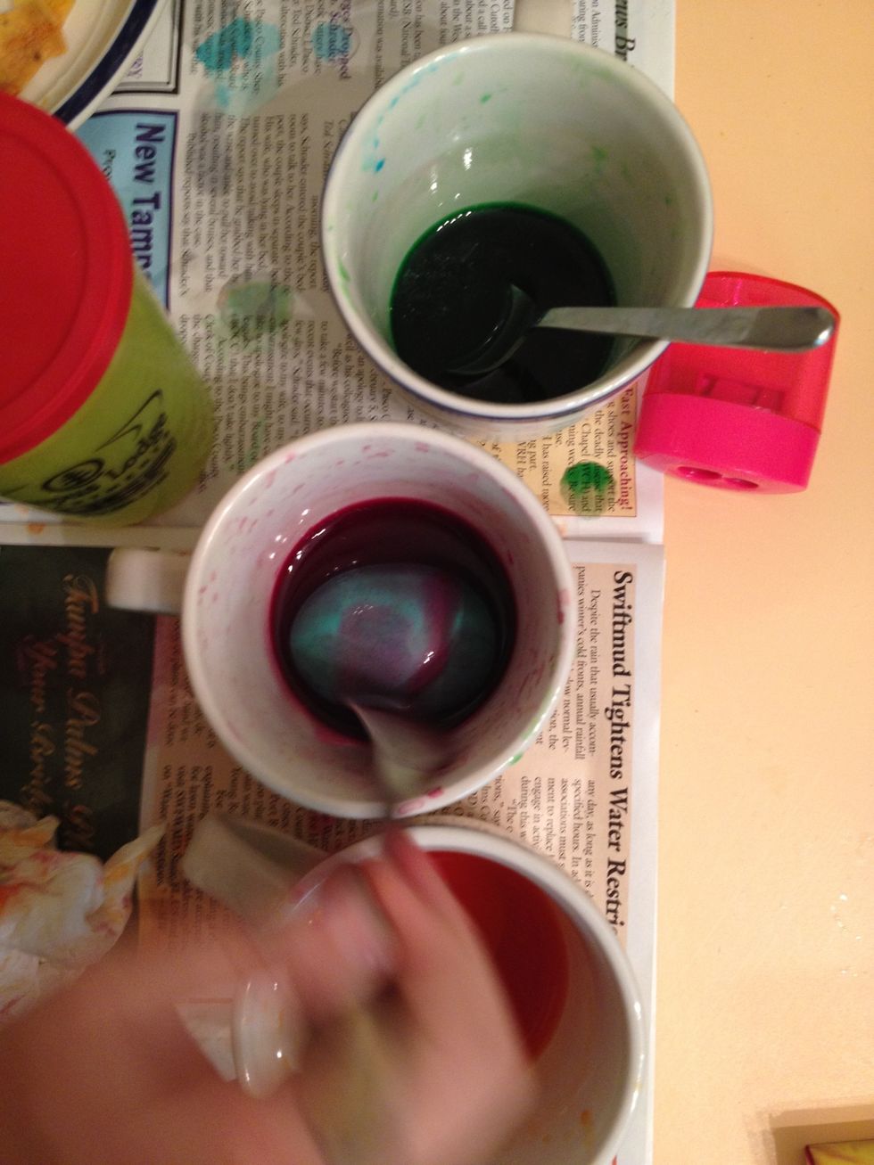 Continue by dipping the egg into each remaining cup.