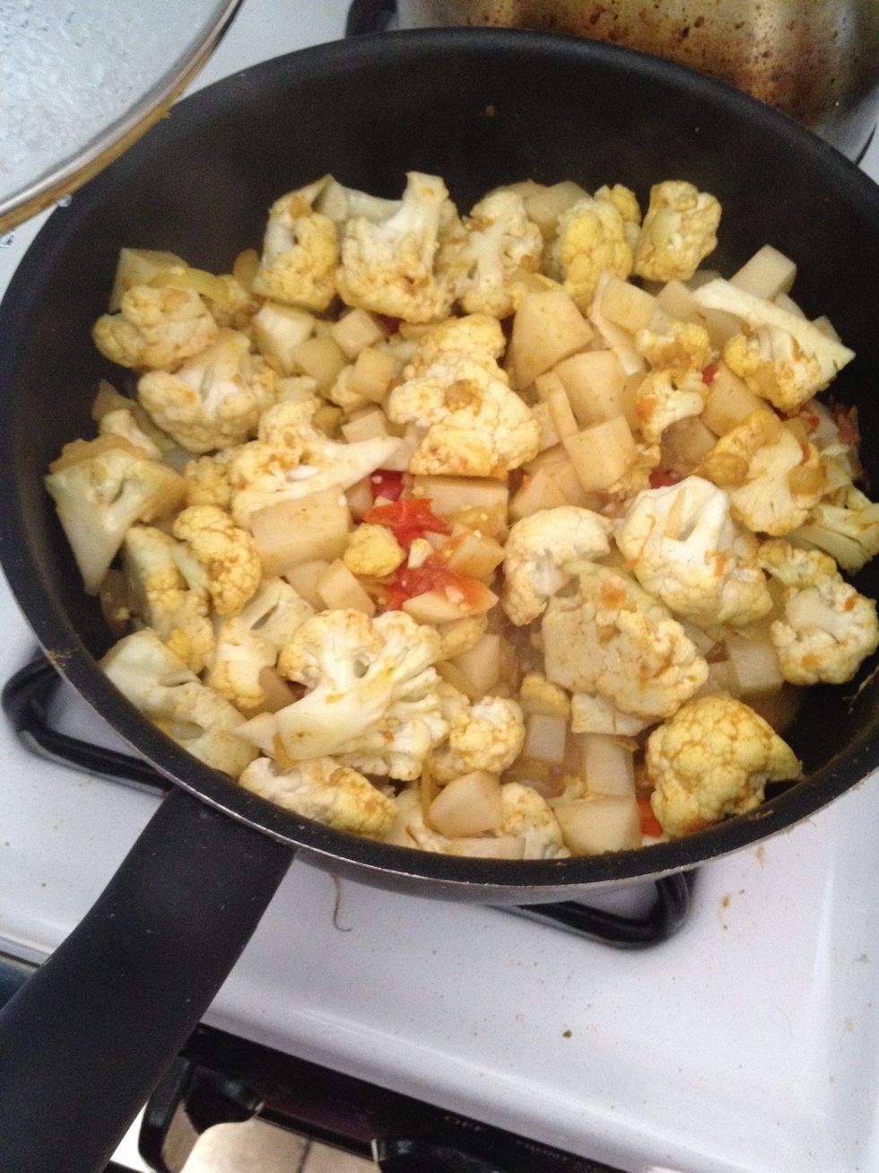Continue cooking 2 more minutes, then stir in the cauliflower, and reduce heat to medium-low.