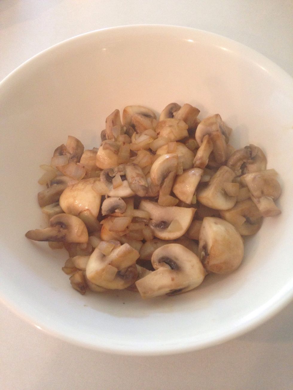 Continue cooking mushrooms and onions. When onions are transparent and mushrooms brown, remove from pan and transfer to bowl.