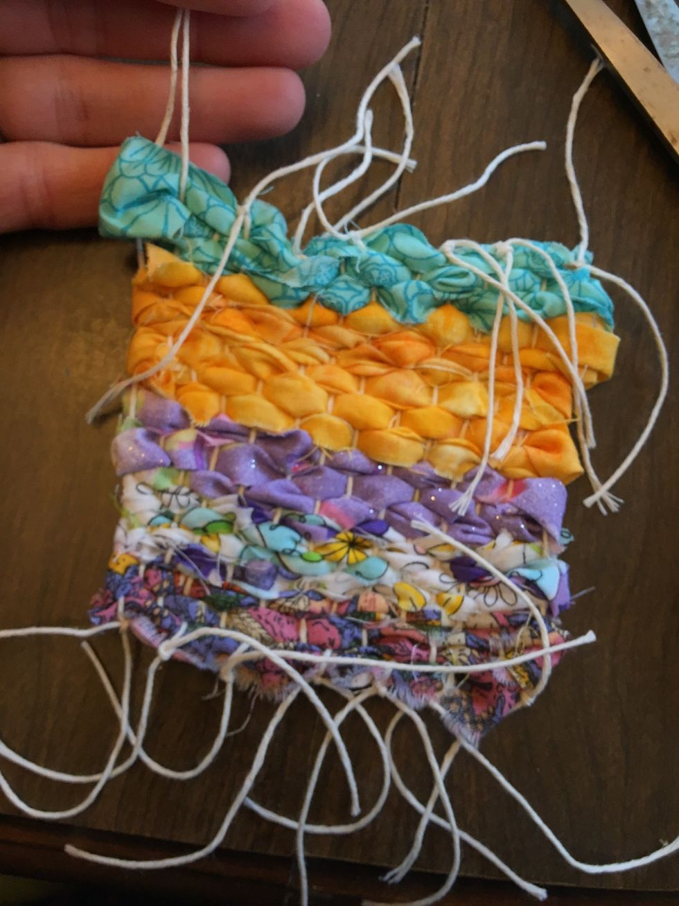 Continue cutting and tying all the way across the loom to the end. You might end up with three strings on one end and I'd that happens, just tie all three together.