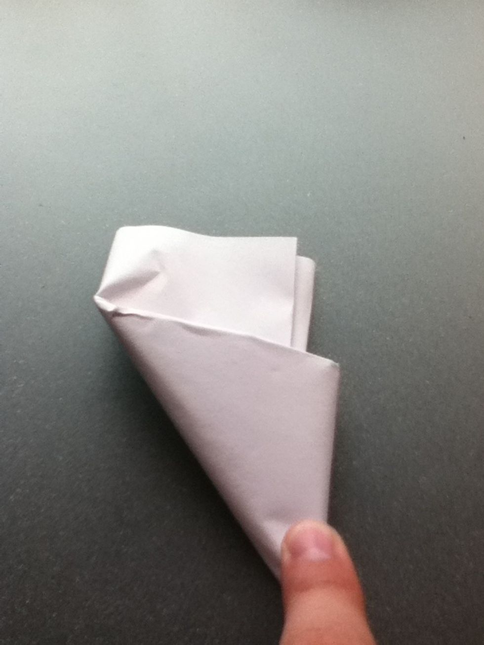 Continue folding until you see a little bit of paper sticking out.