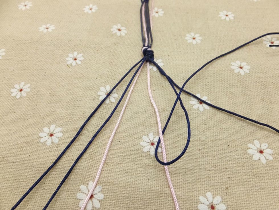 Continue knotting towards the left, until the outermost cord has carried over to the middle. This is one half of the chevron pattern.