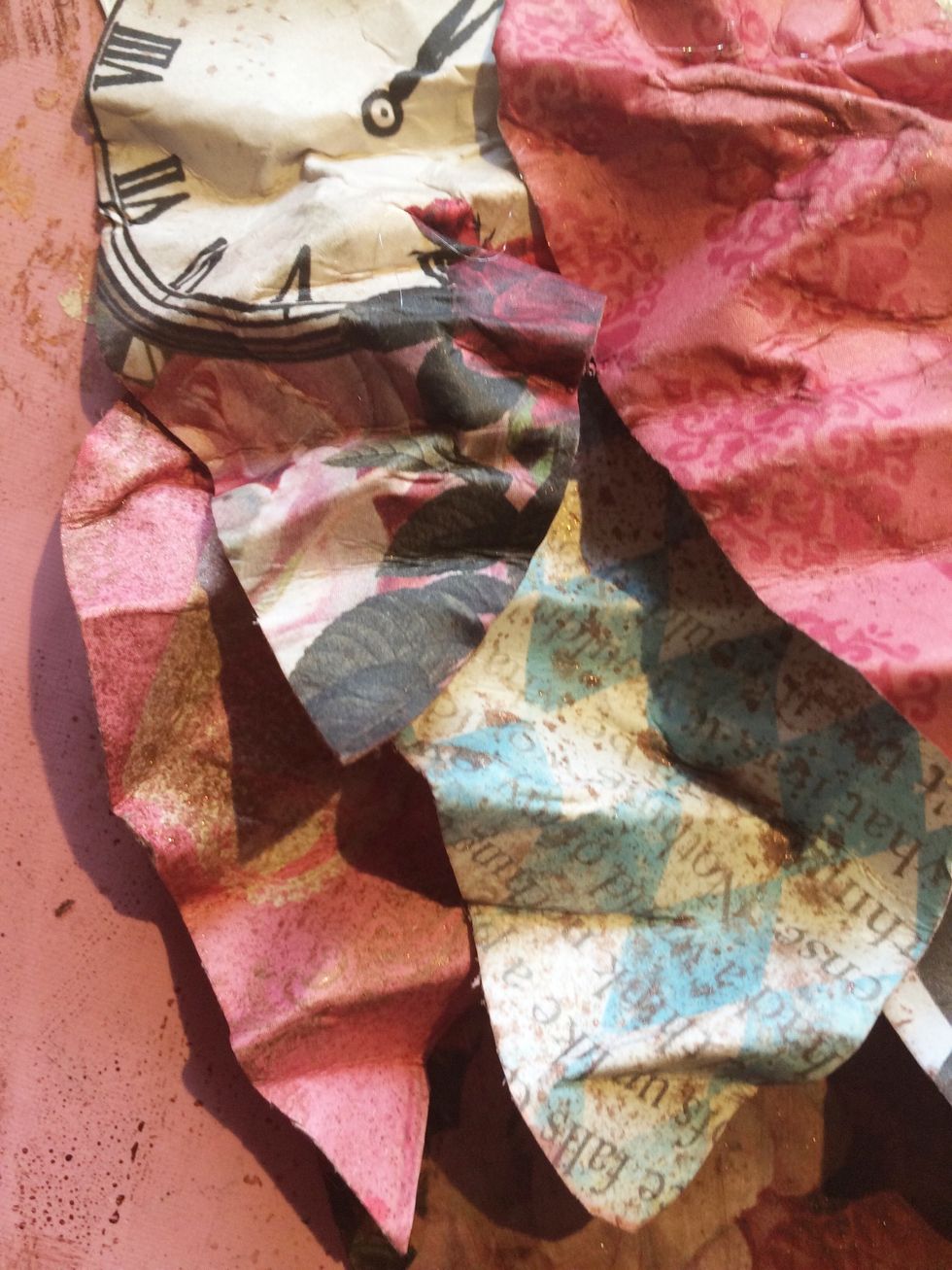 Continue layering your feathers in a row. When you start your next row, place the tip of that feather in between the two feathers below it.