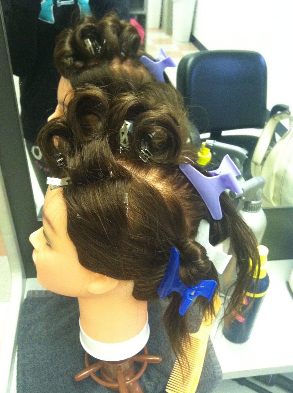 Continue rolling, and spray every curl with hair spray, in the same direction. It should look like this at first. (i didn't have time to finish) & after you finish the whole head, give a final spray.