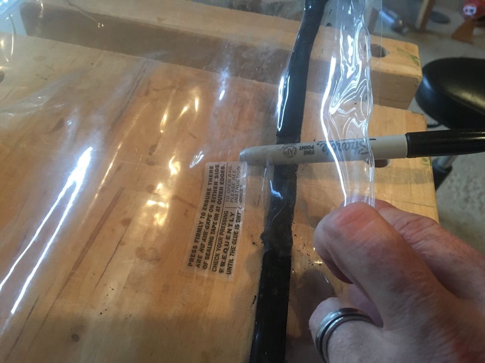 Continue rolling blunt object along sealing tape until the vacuum bag is open.