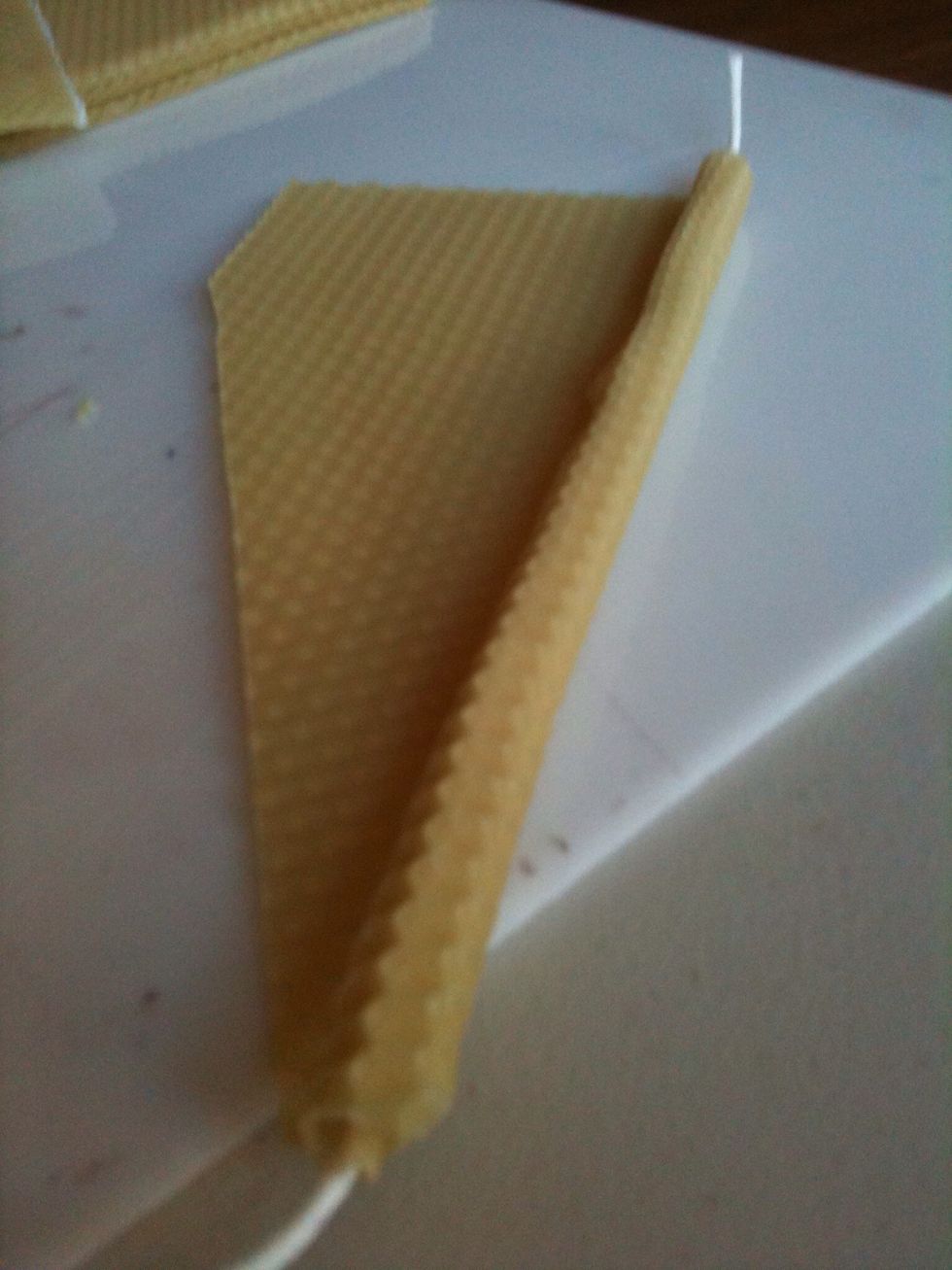 Continue rolling the bottom edge into the bottom of the top piece so that you begin to roll the two sheets of wax together.