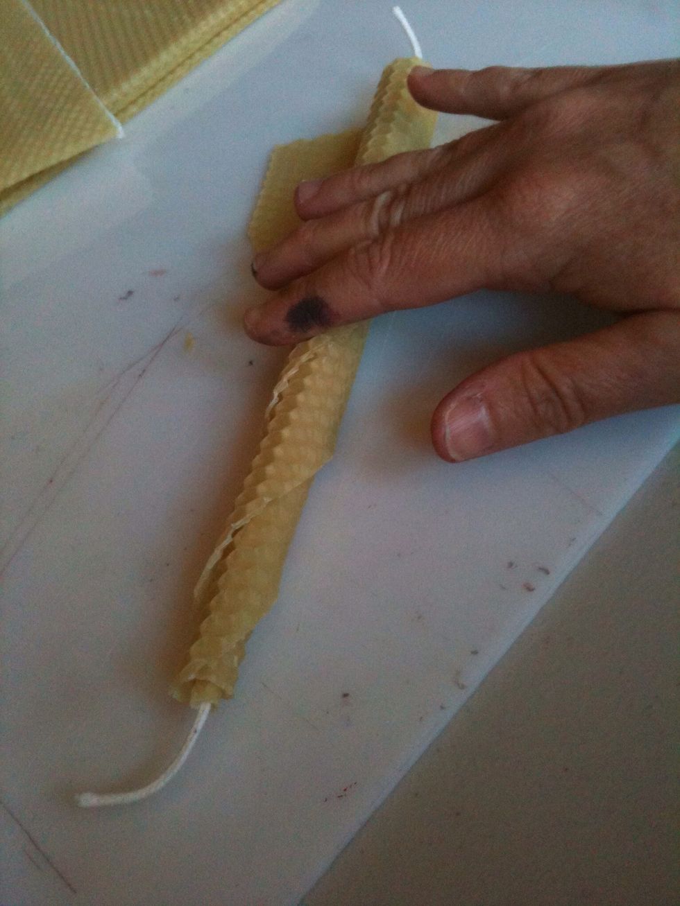 Continue rolling the two sheets of wax together, keeping the roll tight and smooth.  Soon you will be able to easily roll the candle all the way through using your fingertips.