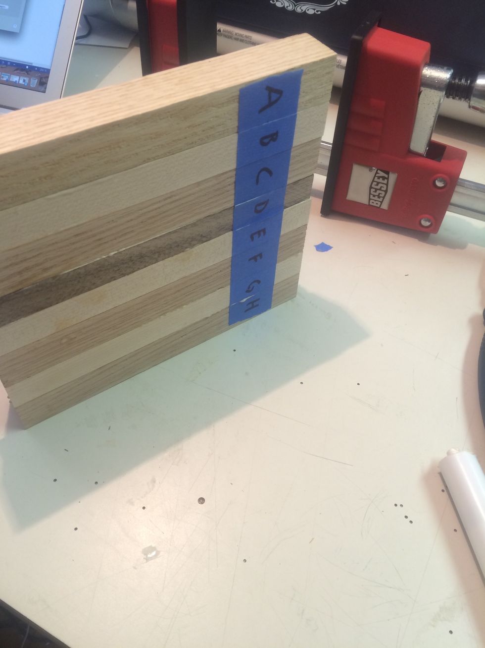 Continue stacking the pieces, adding glue and towels, until the board is fully assembled