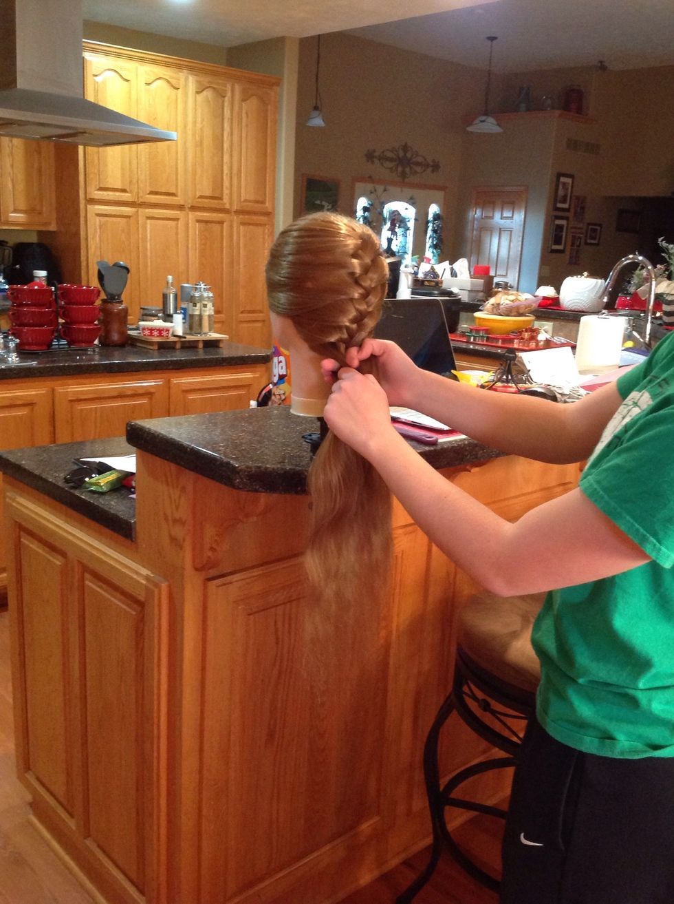 Continue the process of moving outer pieces to the center and adding a new section of hair each time until you run out of new hair to add.