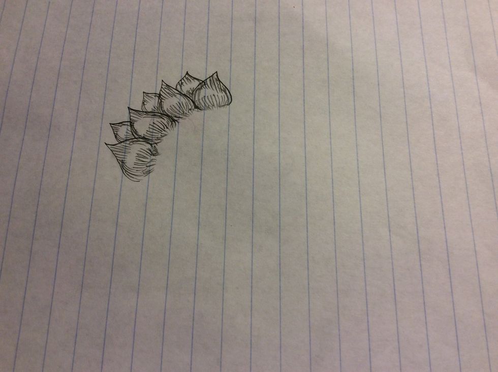 Continue this process until all petals have formed and for the center you can do dots or a spiral.