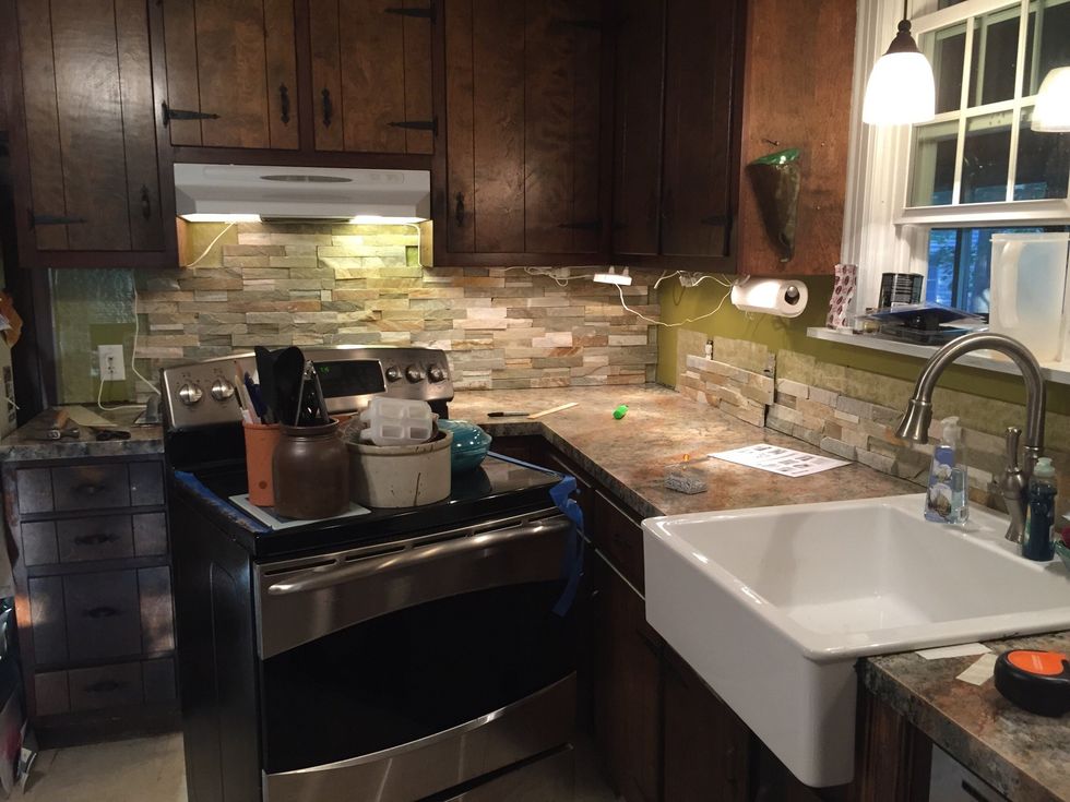 Continue to cut and lay tile on backsplash.