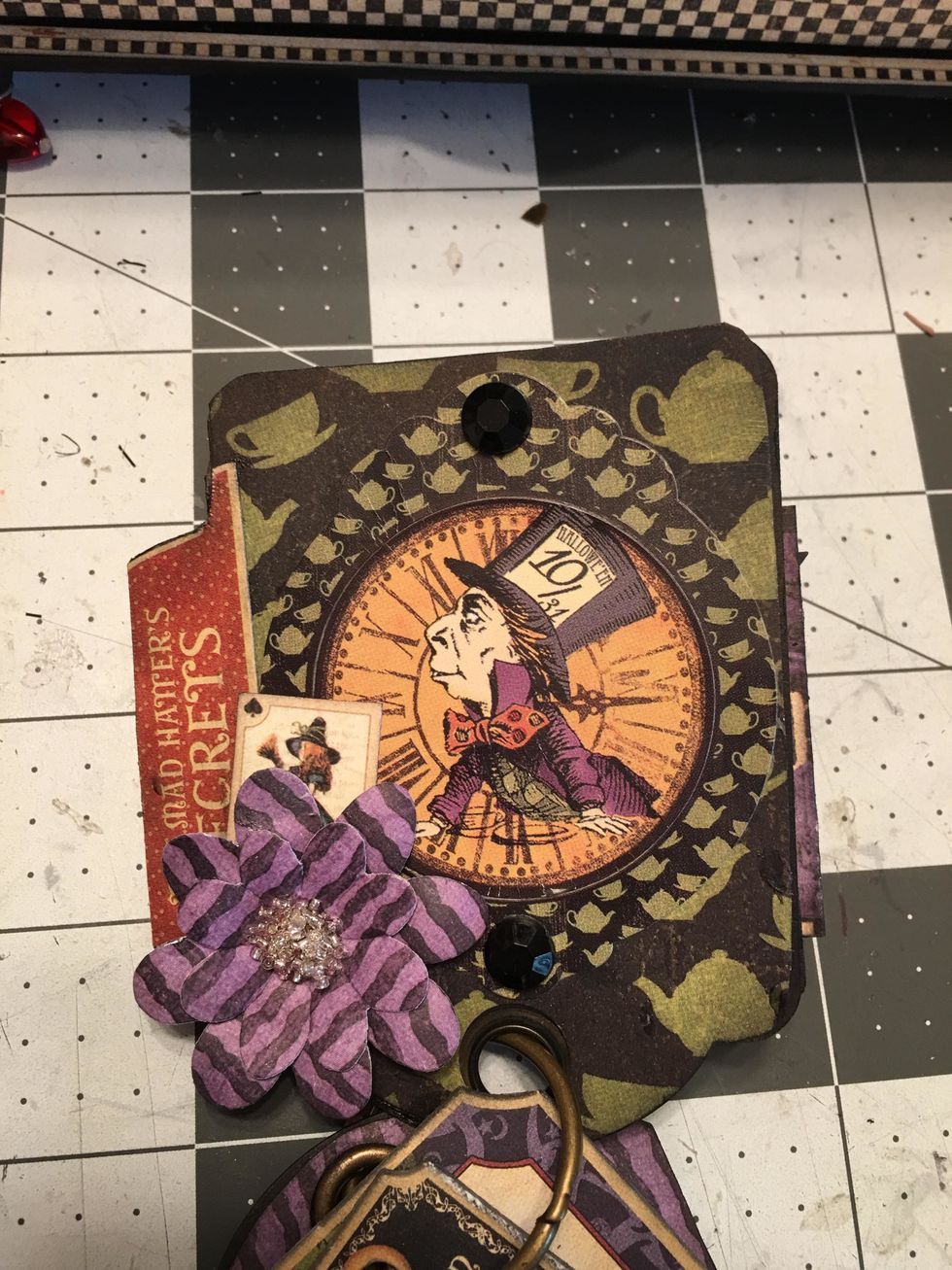 Continue to decorate each tag page with stickers or chipboard frames, flowers punched from the paper collection and different fussy cut elements.