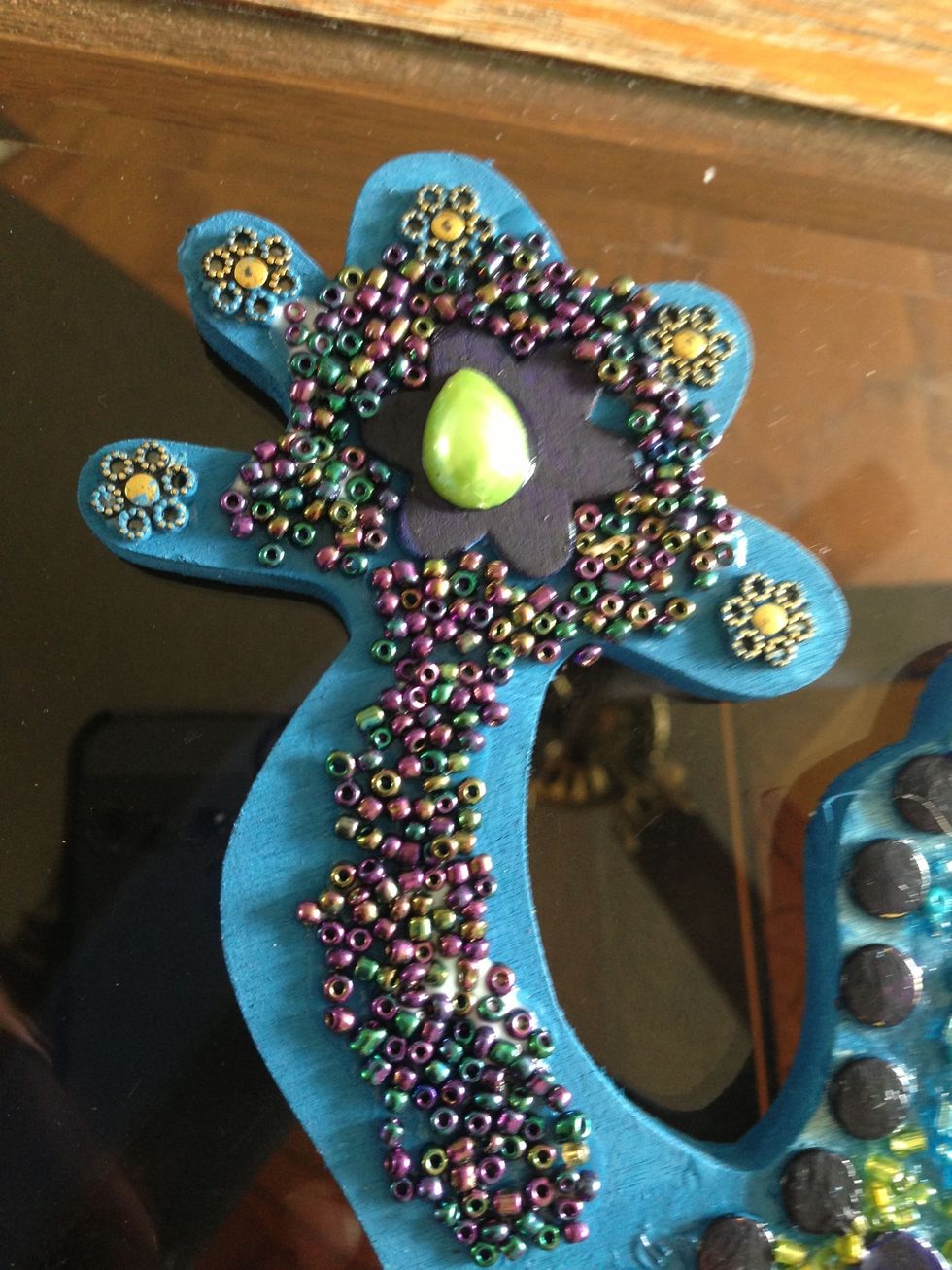 Continue to decorate legs with more beads. Let dry well. The using the white glue and a paint brush. Brush on glue to all areas as a top coat.