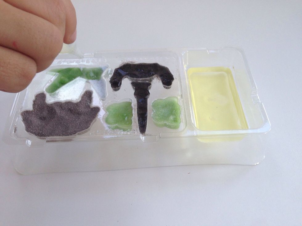 Continue to drop the gummy activator liquid into all powder mold sections