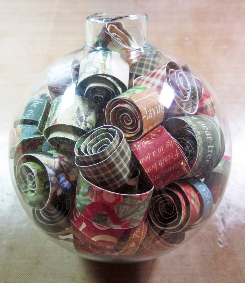 Continue to fill the ball letting some strips uncurl more than others and varying papers so there is a lot of interest in your ornament.