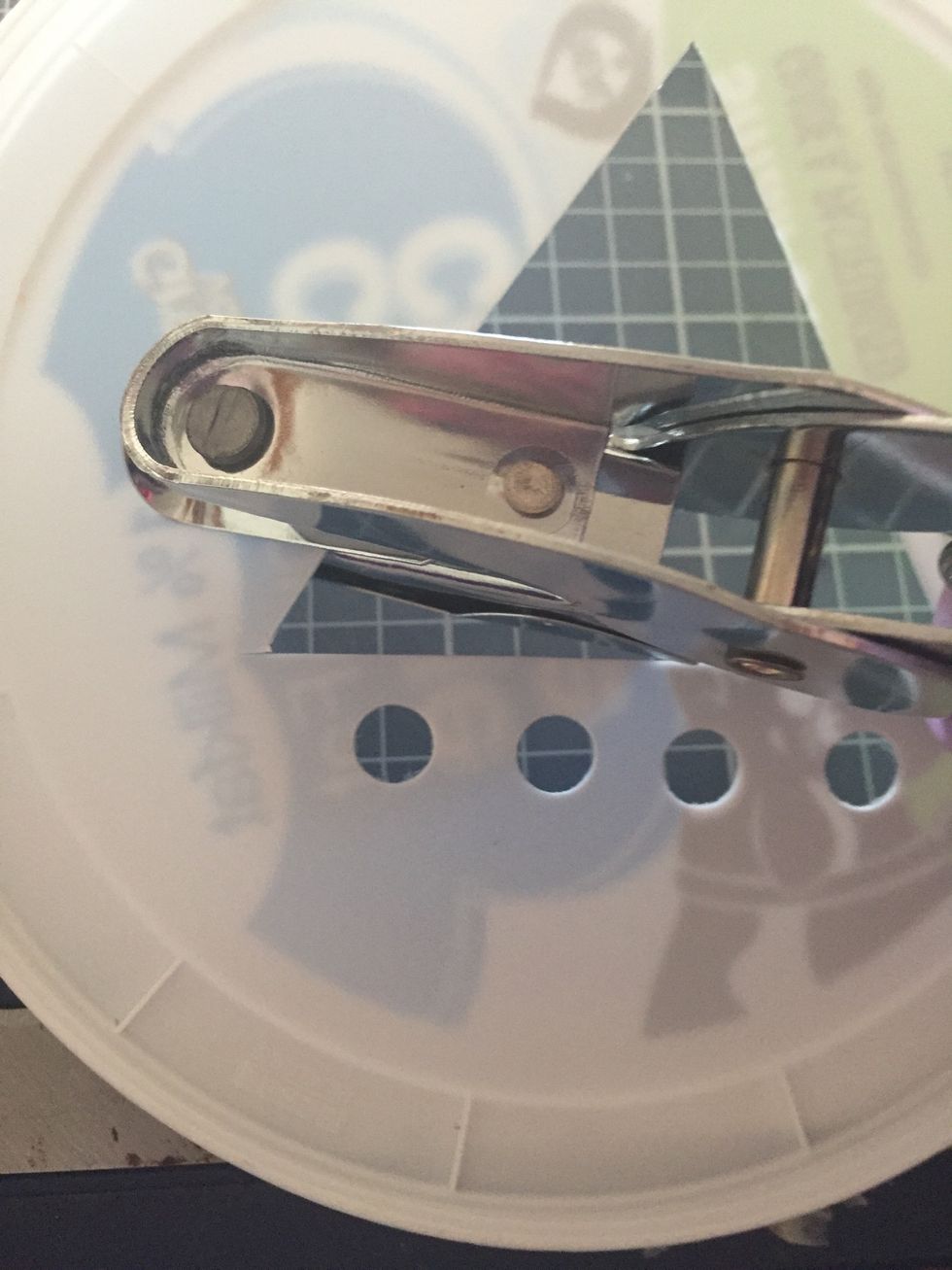 Continue to punch holes on two sides of triangle (be sure to remind kiddos to keep them far enough apart from each other and the cut triangle so their is no space for yarn to slip through)