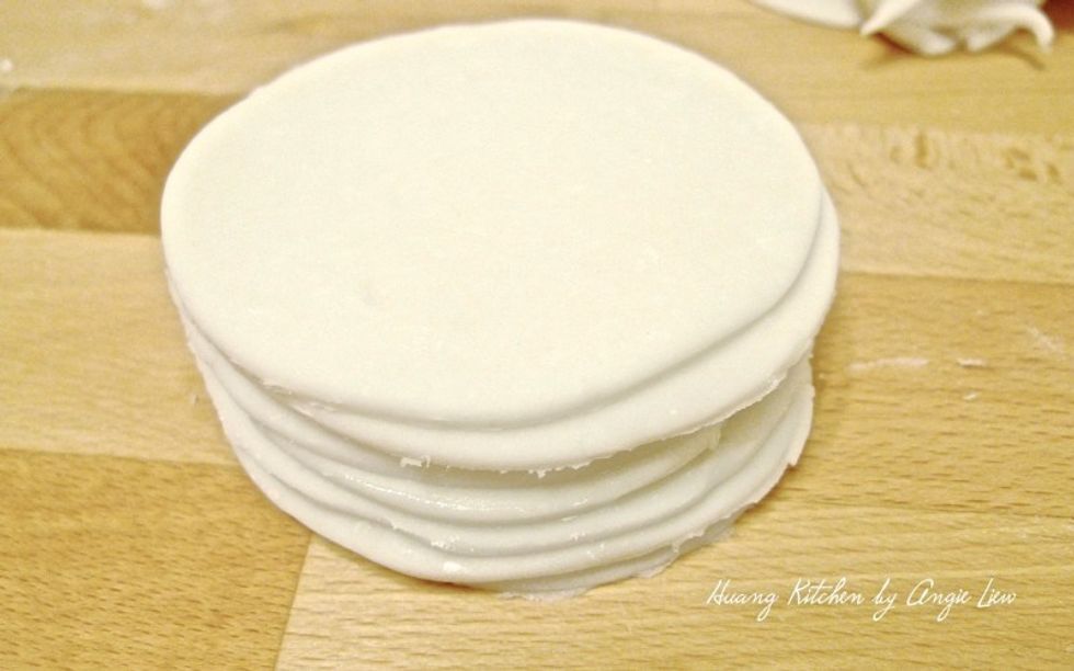 Continue to roll and cut into round wrappers for the rest of the smooth dough.