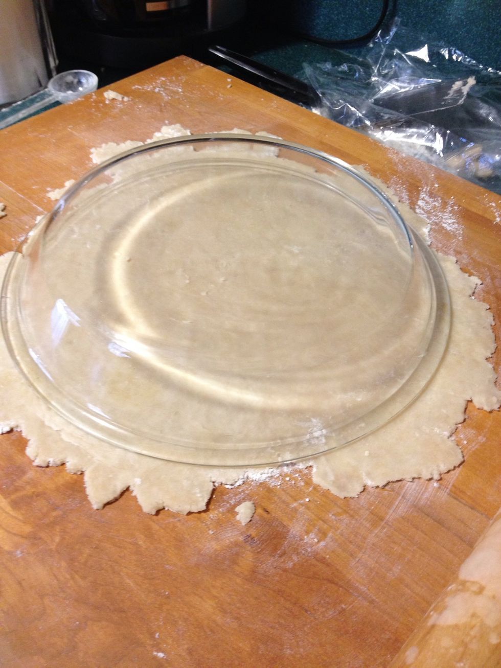 Continue to roll the dough working from left to right and from top to bottom until the crust is about an 1/8th of an inch thick. And until it extends past the edges of the inverted pie plate.