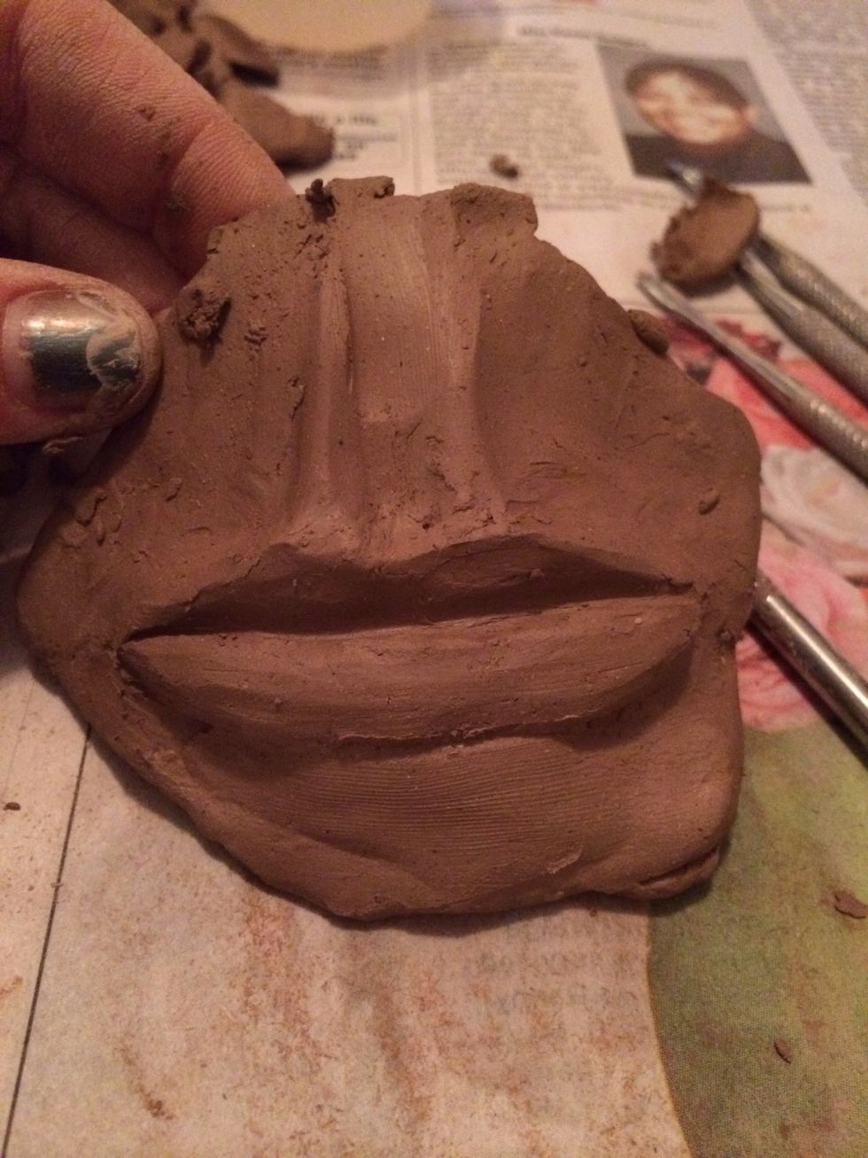 Continue to sculpt the upper and lower lips and also the philtrum until they are the right shape