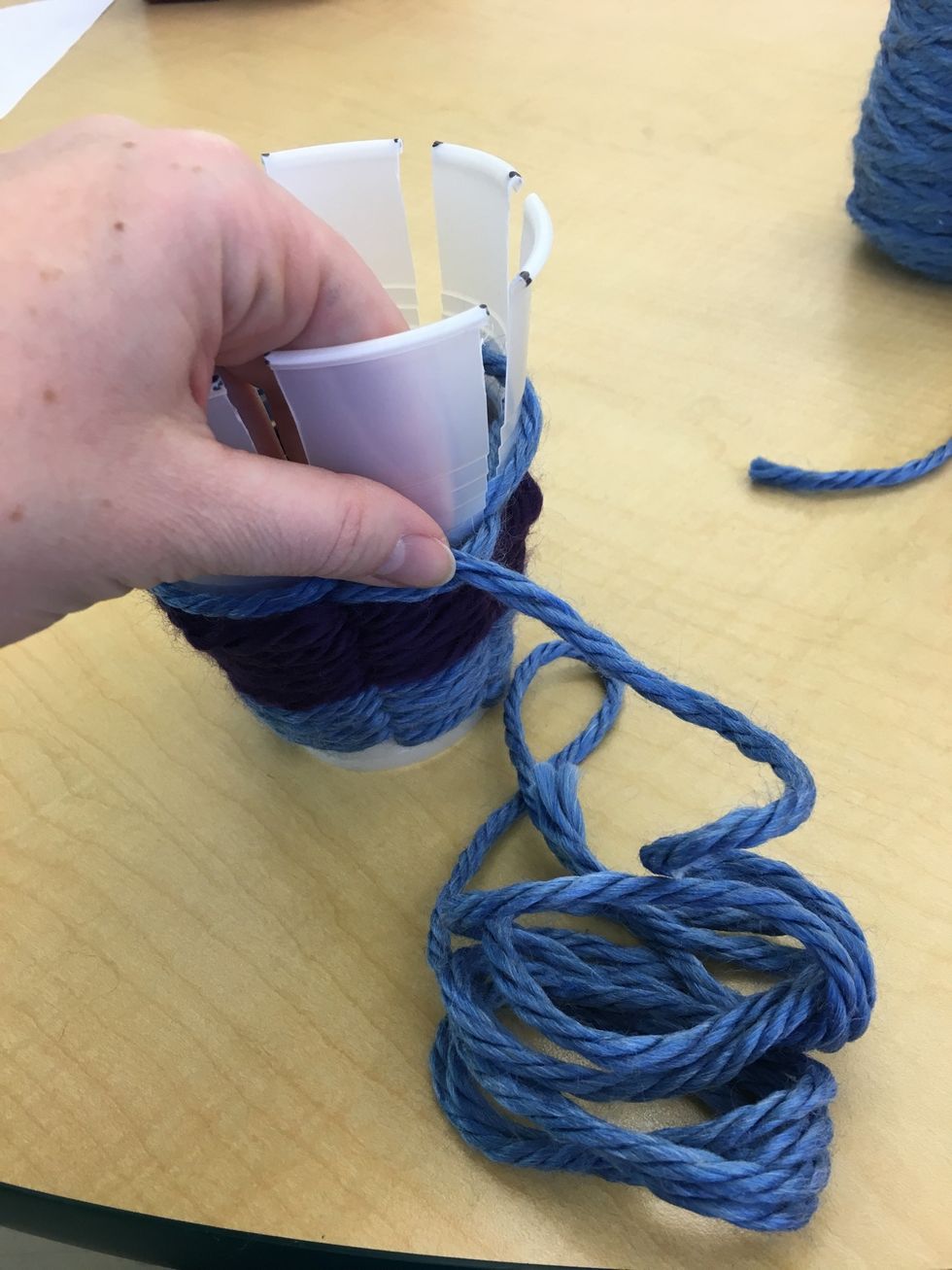 Continue to secure the yarn with your hand.